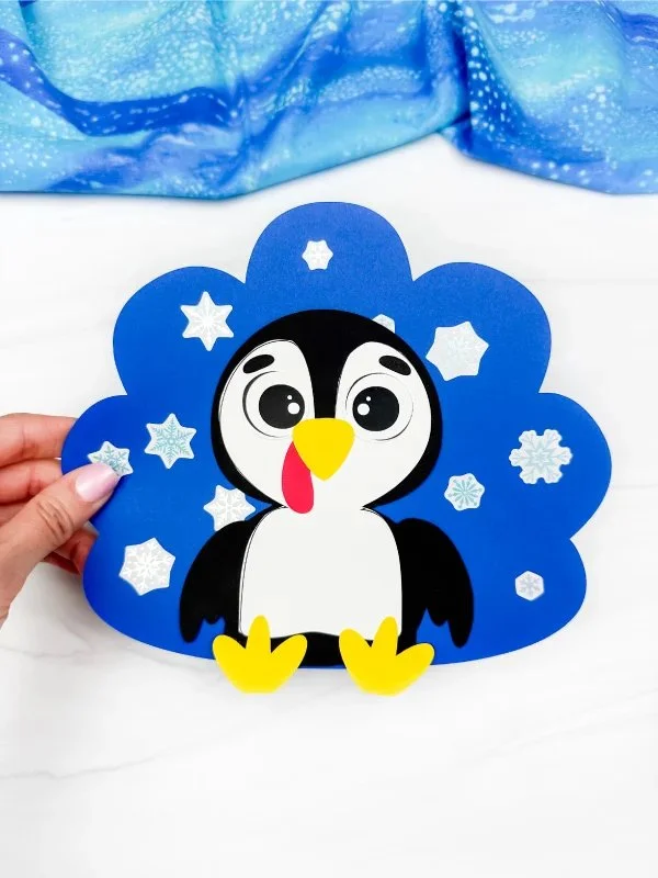 Kids crafting a Penguin Turkey Disguise with a free template.