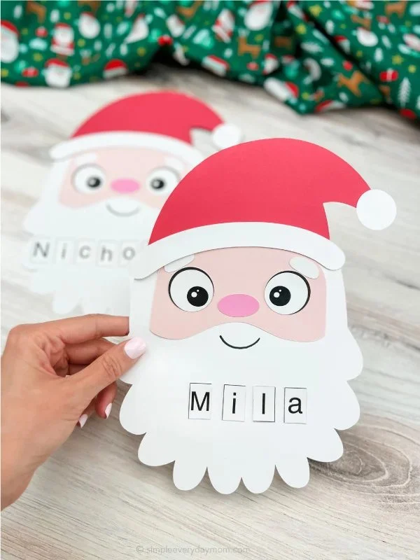 Kids creating a Santa name craft using a free template for Christmas fun.